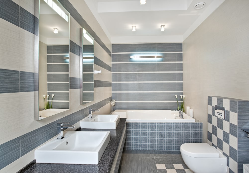 Modern bathroom in blue and gray tones with mosaic on wide angle view