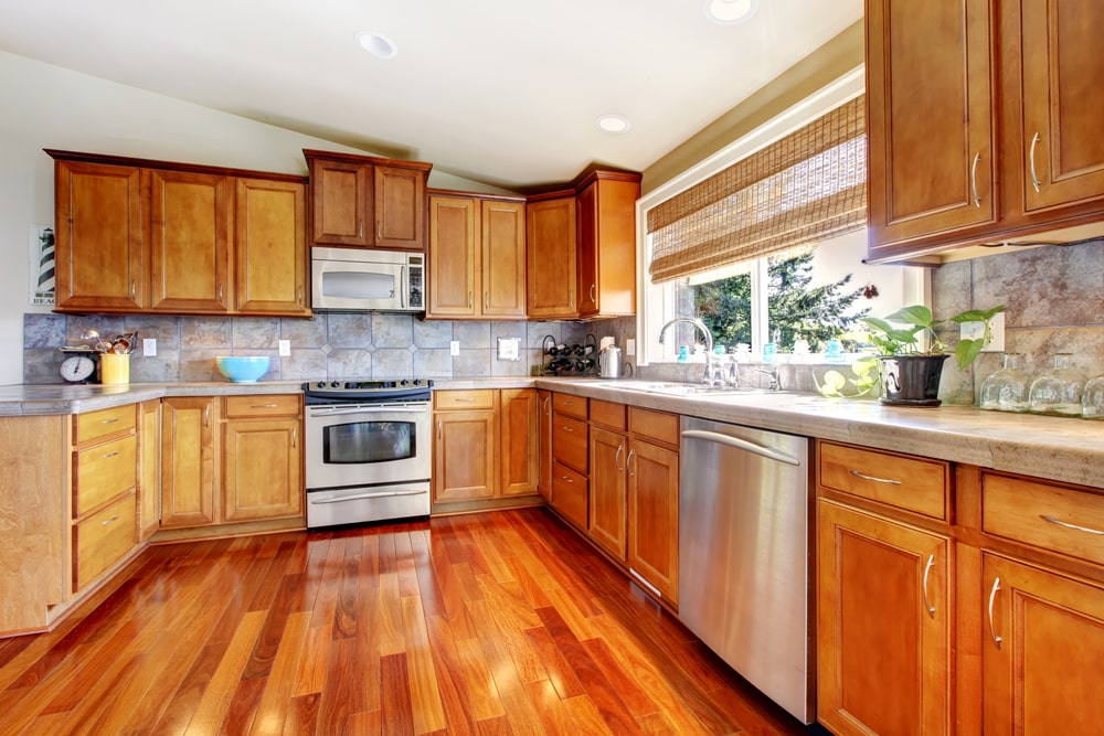 Kitchen interior with lots of wood, stainless steal appliances and wood floors