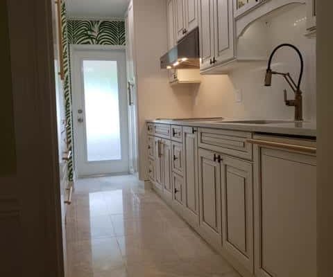 Elegant kitchen renovation featuring custom cabinetry and modern fixtures, showcasing expert design by Palm Beach remodeling specialists in kitchen, home, and bathroom renovations.